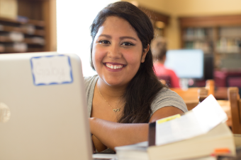 Photo of a student studying in the library