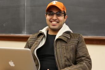 Student with UT cap working on his laptop