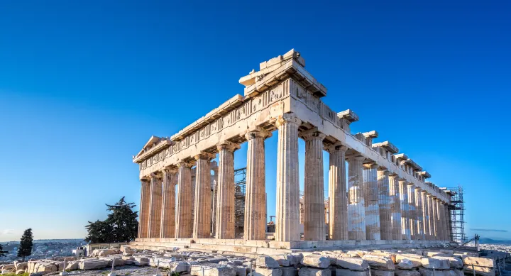 Classic ancient Greek structure with columns standing on a hill top 