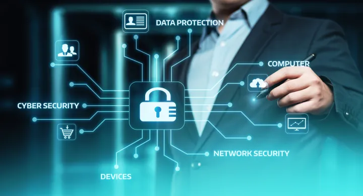 A man standing behind a digital glass screen with an icon of a key lock in the middle and surrounded by cybersecurity-related keywords 